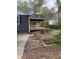 Charming home featuring a covered deck, spacious backyard with a shed, and rock landscaping at 524 S Holly Springs Rd, Woodstock, GA 30188