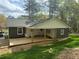 Backyard view of home with a covered porch and a well-maintained lawn at 524 S Holly Springs Rd, Woodstock, GA 30188