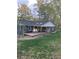 Backyard view of home with a covered porch and a well-maintained lawn at 524 S Holly Springs Rd, Woodstock, GA 30188