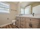Bathroom featuring a double sink vanity with wood finishings and updated fixtures at 524 S Holly Springs Rd, Woodstock, GA 30188