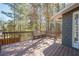 Spacious wooden deck with built-in bench seating and lots of shade from nearby trees at 524 S Holly Springs Rd, Woodstock, GA 30188