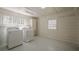 Bright laundry room featuring a washer, dryer, and ample storage space at 524 S Holly Springs Rd, Woodstock, GA 30188