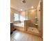 A well-lit bathroom with a glass-enclosed shower and soaking tub at 3049 Morgan Spring Trl, Buford, GA 30519