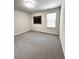 Bright bedroom featuring a picture window, perfect for relaxation at 3049 Morgan Spring Trl, Buford, GA 30519