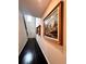 Bright entryway with hardwood floors, beautiful art, and a staircase leading to the upper level at 3049 Morgan Spring Trl, Buford, GA 30519