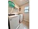 Laundry room equipped with modern washer and dryer units and shelving at 3049 Morgan Spring Trl, Buford, GA 30519