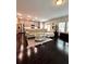 Open-concept living area with hardwood floors, a comfortable seating area, and a modern kitchen view at 3049 Morgan Spring Trl, Buford, GA 30519