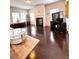 Well-lit living room with hardwood floors, a fireplace, and comfortable seating and entertainment area at 3049 Morgan Spring Trl, Buford, GA 30519