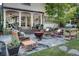 Backyard featuring a stone patio with comfortable seating, wood burning fire pit, and outdoor grill at 4000 N Stratford Ne Rd, Atlanta, GA 30342