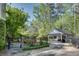 Private backyard featuring a paved patio, outdoor seating, grilling area, and two-car detached garage at 4000 N Stratford Ne Rd, Atlanta, GA 30342