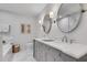 Bright bathroom with dual sinks, gray vanity, marble countertop, and decorative wall art at 4000 N Stratford Ne Rd, Atlanta, GA 30342