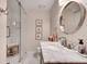Cozy bathroom includes a shower, vanity with marble countertop, and round mirror at 4000 N Stratford Ne Rd, Atlanta, GA 30342