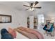 Comfortable bedroom featuring a ceiling fan, closet, and a relaxing blue chair at 4000 N Stratford Ne Rd, Atlanta, GA 30342