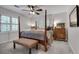 Bright bedroom featuring four-poster bed, ceiling fan, plantation shutters, and neutral color scheme at 4000 N Stratford Ne Rd, Atlanta, GA 30342