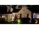 Charming white brick home featuring black shutters, a classic gable roof and beautiful outdoor lighting at 4000 N Stratford Ne Rd, Atlanta, GA 30342