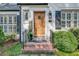 Beautiful entryway showcasing a wood door, brick steps, and manicured shrubs enhancing the home's curb appeal at 4000 N Stratford Ne Rd, Atlanta, GA 30342