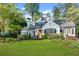 Beautiful two-story home with lush green lawn, mature trees, and classic architectural details at 4000 N Stratford Ne Rd, Atlanta, GA 30342