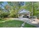 Detached two-car garage with white trim and siding, set on manicured lawn and landscaping at 4000 N Stratford Ne Rd, Atlanta, GA 30342