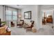 Comfortable sitting room with hardwood chairs, soft natural lighting and view into a spacious bedroom at 4000 N Stratford Ne Rd, Atlanta, GA 30342