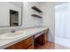 Bathroom featuring modern countertops, wooden shelves, and a shower with a curtain at 4183 Oak Crest Dr, Tucker, GA 30084