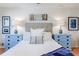 Bright main bedroom with blue nightstands, white bedding, and decorative lamps at 4183 Oak Crest Dr, Tucker, GA 30084
