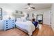 Stylish bedroom with hardwood floors, blue nightstands, and ensuite bathroom at 4183 Oak Crest Dr, Tucker, GA 30084
