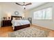 Bright bedroom with hardwood floors, a window, and a bed with lamps at 4183 Oak Crest Dr, Tucker, GA 30084