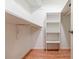 Walk-in closet with custom shelving and hardwood floors at 4183 Oak Crest Dr, Tucker, GA 30084