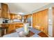 Kitchen island transitions to a dining area with wood table, chairs, and natural light at 4183 Oak Crest Dr, Tucker, GA 30084