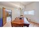 Dining room with hardwood floors, modern light fixture, and view to the yard through the window at 4183 Oak Crest Dr, Tucker, GA 30084