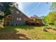Exterior view of the home featuring a deck, well-maintained yard and beautiful trees at 4183 Oak Crest Dr, Tucker, GA 30084