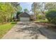 Home exterior featuring a garage, driveway, and landscaped front yard at 4183 Oak Crest Dr, Tucker, GA 30084