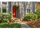 Close-up of a home's red front door with gray siding and blooming azaleas at 4183 Oak Crest Dr, Tucker, GA 30084