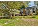 Landscaped front yard with stone walkway leading to a charming home with a stone chimney at 4183 Oak Crest Dr, Tucker, GA 30084