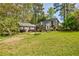 Charming home with a well-manicured lawn, stone chimney, and beautiful landscaping at 4183 Oak Crest Dr, Tucker, GA 30084