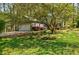 Charming home with a well-manicured lawn, flowering shrubs, and a two-car attached garage at 4183 Oak Crest Dr, Tucker, GA 30084