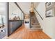 Hallway with hardwood floors and staircase leading to the upper level, offering a bright and inviting atmosphere at 4183 Oak Crest Dr, Tucker, GA 30084