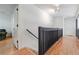 Well-lit hallway featuring hardwood floors and a staircase with wooden railing at 4183 Oak Crest Dr, Tucker, GA 30084