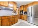 Spacious kitchen with wood cabinets, stainless steel refrigerator, and built-in oven/microwave at 4183 Oak Crest Dr, Tucker, GA 30084