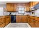 A cozy kitchen featuring granite countertops, wooden cabinets, and stainless steel appliances at 4183 Oak Crest Dr, Tucker, GA 30084