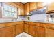 Close-up of updated kitchen featuring wood cabinets, granite counters, and gray tile backsplash at 4183 Oak Crest Dr, Tucker, GA 30084