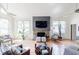 Open living room with vaulted ceilings, hardwood floors, stone fireplace, and natural light at 4183 Oak Crest Dr, Tucker, GA 30084