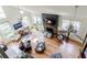 An aerial view showcasing a bright living room featuring a stone fireplace with a mounted TV and many windows at 4183 Oak Crest Dr, Tucker, GA 30084