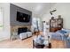 Bright living room features a stone fireplace with TV, hardwood floors, and plenty of natural light at 4183 Oak Crest Dr, Tucker, GA 30084