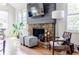 Living room featuring a stone fireplace, hardwood floors, and windows allowing natural light at 4183 Oak Crest Dr, Tucker, GA 30084