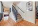Entryway features hardwood floors, carpet stairs with railing, and art on the wall at 4183 Oak Crest Dr, Tucker, GA 30084