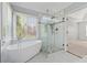 Bathroom featuring a luxurious soaking tub and frameless glass shower at 1075 Pebble Bend Dr, Grayson, GA 30017