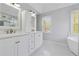 Bright bathroom with double sink vanity, walk-in shower, and soaking tub at 1075 Pebble Bend Dr, Grayson, GA 30017