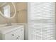 Bright bathroom with an oval mirror and white vanity at 1075 Pebble Bend Dr, Grayson, GA 30017