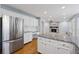 Well-appointed kitchen with white cabinetry, granite countertops and stainless steel appliances at 1075 Pebble Bend Dr, Grayson, GA 30017